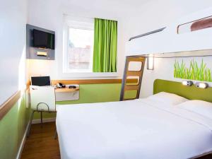 sypialnia z łóżkiem i biurkiem z laptopem w obiekcie ibis budget Campo Grande w mieście Campo Grande