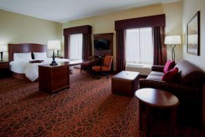 a hotel room with a bed and a couch at Hampton Inn & Suites Minot in Minot