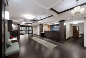 a lobby of a hotel with a welcome sign on the wall at Hampton Inn Marshall in Marshall