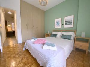 a bedroom with two beds with towels on them at MediTerra Stay in the heart of Athens in Athens