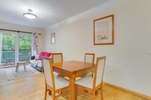 a dining room with a wooden table and chairs at Isabel Apartment by Holiday Rental Madeira in Ribeira Brava
