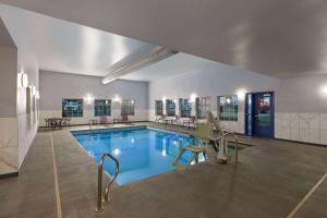 a large swimming pool in a building at La Quinta by Wyndham Olathe in Olathe