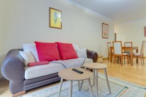 a living room with a couch and two tables at Isabel Apartment by Holiday Rental Madeira in Ribeira Brava