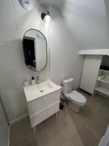 a white bathroom with a sink and a toilet at Studio 1 - Mi-Côte - Studio à Orvault in Orvault