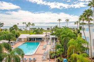 an aerial view of a resort with a pool and palm trees at Safety Harbor Resort & Spa Trademark Collection by Wyndham in Safety Harbor