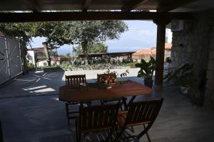 a wooden table with chairs and a bowl of fruit on it at Villa Serena in Vico Equense