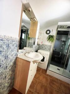 a bathroom with a sink and a shower at Casa de la Luz in Cuevas del Campo