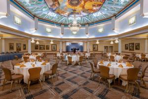 a banquet hall with tables and chairs and a chandelier at Safety Harbor Resort & Spa Trademark Collection by Wyndham in Safety Harbor