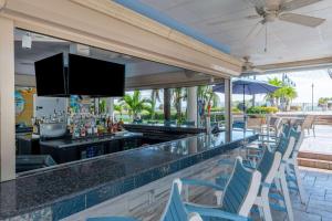 a bar in a resort with blue chairs and a counter at Safety Harbor Resort & Spa Trademark Collection by Wyndham in Safety Harbor