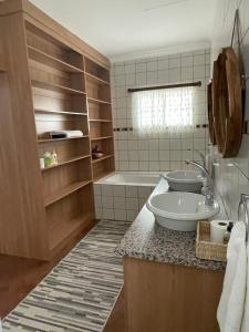 a bathroom with a sink and a bath tub at City comfort self catering Windhoek in Windhoek