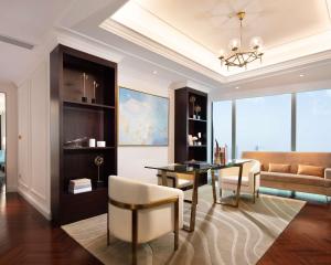 a living room with a dining table and a couch at The Lixury Hotel, in The Unbound Collection by Hyatt in Chongqing