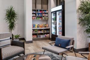 a waiting room with two chairs and a refrigerator at Hyatt House Denver Aurora Anschutz Medical Campus in Aurora