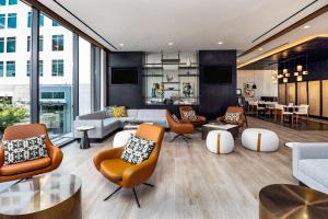 a living room with couches and chairs at Hyatt Centric Charlotte SouthPark in Charlotte