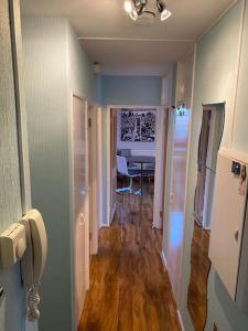 a hallway with a dining room and a dining table at Entire flat, comfortable 2 double bedrooms in Woolwich