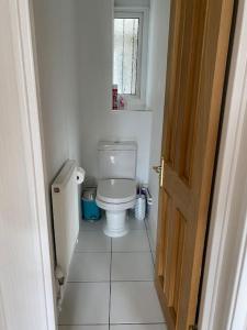 a small bathroom with a toilet and a window at Entire flat, comfortable 2 double bedrooms in Woolwich