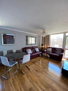 a living room with a couch and a table at Entire flat, comfortable 2 double bedrooms in Woolwich