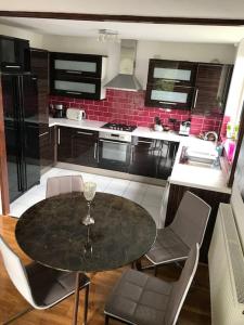a kitchen with a table and chairs in a kitchen at Entire flat, comfortable 2 double bedrooms in Woolwich
