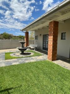 a patio with a fountain in front of a house at City comfort self catering Windhoek in Windhoek +19 photos