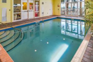 a swimming pool with blue water in a building at Hilton Vacation Club The Cove on Ormond Beach in Ormond Beach