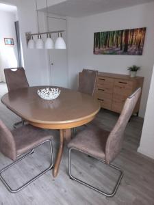 a dining room table with two chairs and a table at Haus Elsholz Usseln FeWo Birke in Willingen