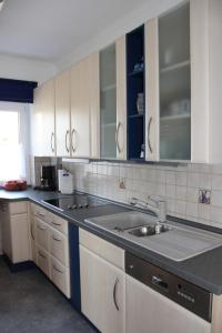 a kitchen with white cabinets and a sink at Haus Elsholz Usseln FeWo Birke in Willingen