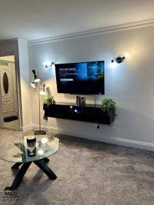 a living room with a flat screen tv on a wall at Kettering/Stylish/ Perfect for Contractors in Kettering