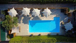 an overhead view of a swimming pool next to a building at Vournelis Beach Hotel and Spa in Iraklitsa