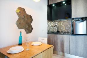 a kitchen with a wooden table with two glasses on it at Espanhouse Magani in Torrevieja