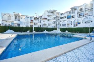 a large swimming pool in front of some buildings at Espanhouse Magani in Torrevieja