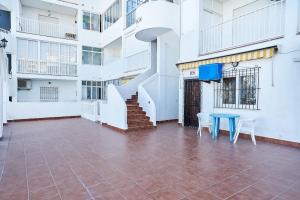 a room with a table and a staircase in a building at Espanhouse Magani in Torrevieja