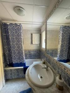 a bathroom with a sink and a mirror and a tub at Casa Amarela Guesthouse, Algorfa by Primavera GuestHouses in Algorfa +32 photos