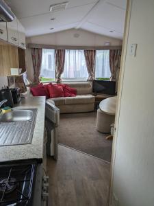 a kitchen and living room in an rv at The Ocean Pearl caravan number 50 situated on the Cove holiday park in Southwell