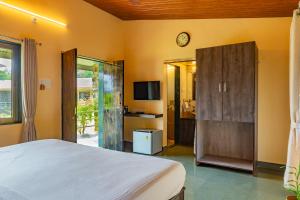 a bedroom with a bed and a tv and a room at CASA AMORA in Lonavala