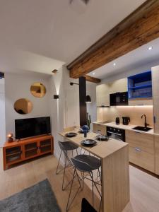 une cuisine avec une table, deux chaises et un comptoir dans l'établissement Les appartements Hyper centre, à Strasbourg