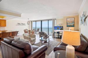 a living room with leather furniture and a view of the ocean at Trillium 2A - Premier in St. Pete Beach