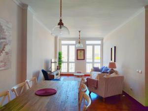 a living room with a wooden table and chairs at Duodecima in Las Palmas de Gran Canaria