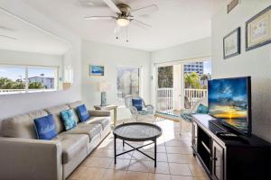 a living room with a couch and a tv at Sunset Vistas 206S in St. Pete Beach