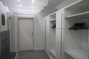 a white walk in closet with a white ceiling at Brauhaus Suite 19 in Sebnitz