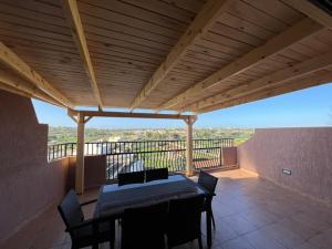 a patio with a table and chairs on a balcony at 2 Bedroom Penthouse with country and sea views in Marsaskala