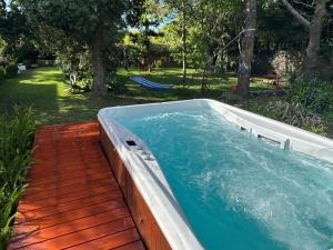 a swimming pool on a wooden deck with at Casa Villa Garden in Ponta Delgada