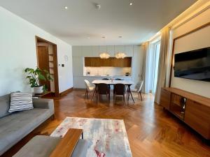 a living room with a table and a kitchen at MBroker - Porto Montenegro Elena residence apartments in Tivat
