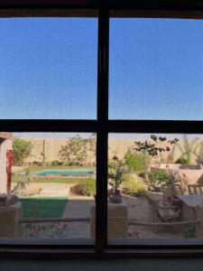 a view out of a window of a yard at Agpeninshal Ecolodge in Siwa