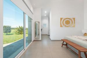a bedroom with a bed and a large glass window at Casa Blanca in Sencelles