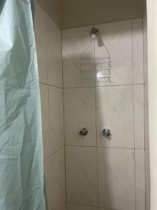 a shower with a glass door with a shower at Pogas Inn in Kingston