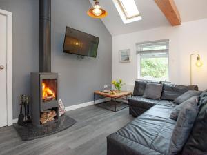 a living room with a couch and a fireplace at Meadow View - Uk44608 in Carnbrea