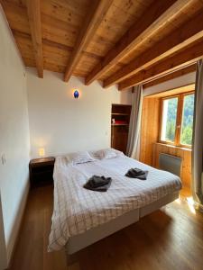 a bedroom with a bed with two towels on it at Apartment Cascade 3 minutes from Alpe d Huez Grand Domaine via Oz en Oisans in Oz