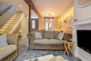 a living room with a couch and a fireplace at Bibi Tongeren in Tongeren