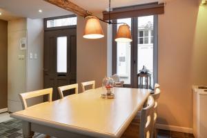 a dining room with a wooden table and chairs at Bibi Tongeren in Tongeren