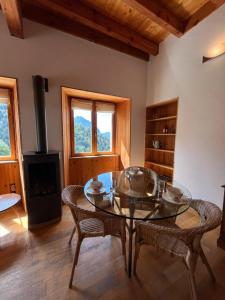 a living room with a table and chairs and a stove at Apartment Cascade 3 minutes from Alpe d Huez Grand Domaine via Oz en Oisans in Oz
