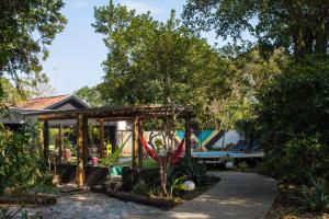 a house with a playground in the yard at Pousada Vila do Mel in Pontal do Paraná